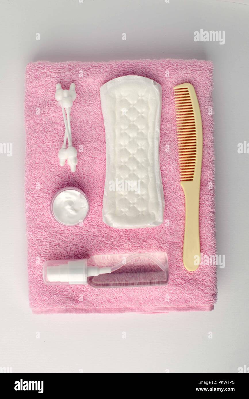 Different personal hygiene objects on white and pink turkish towel background, top view Stock