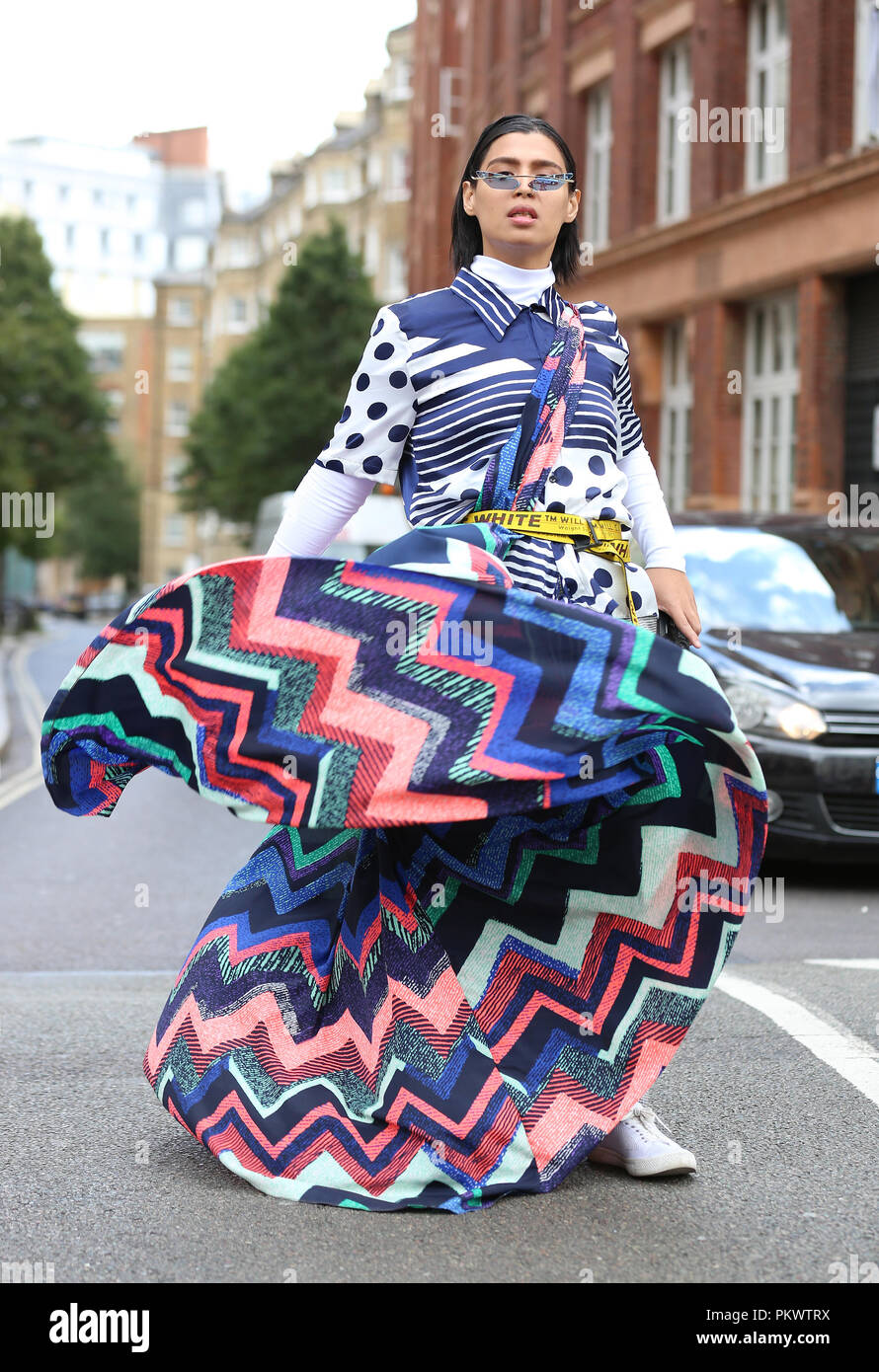 Fashion Curator  Ryle Tuvierra, from Dubai, wears Off-White - Canvas-jacquard belt and self-made design outside Freemasons' Hall during the London Fashion Week September 2018. Stock Photo