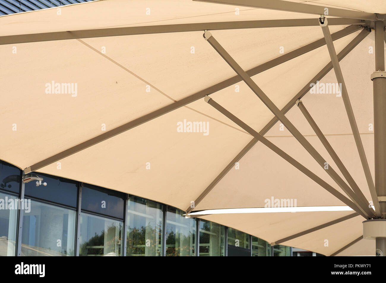 view into canopy frame of a sunshade beside office building with glass facade Stock Photo Alamy