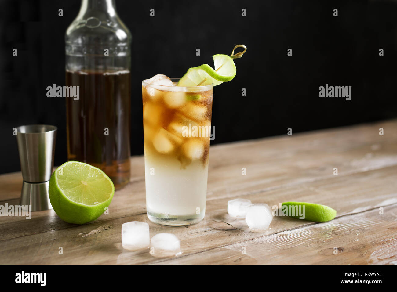 Dark and Stormy Rum Cocktail with Ginger Beer and Lime garnish. Glass