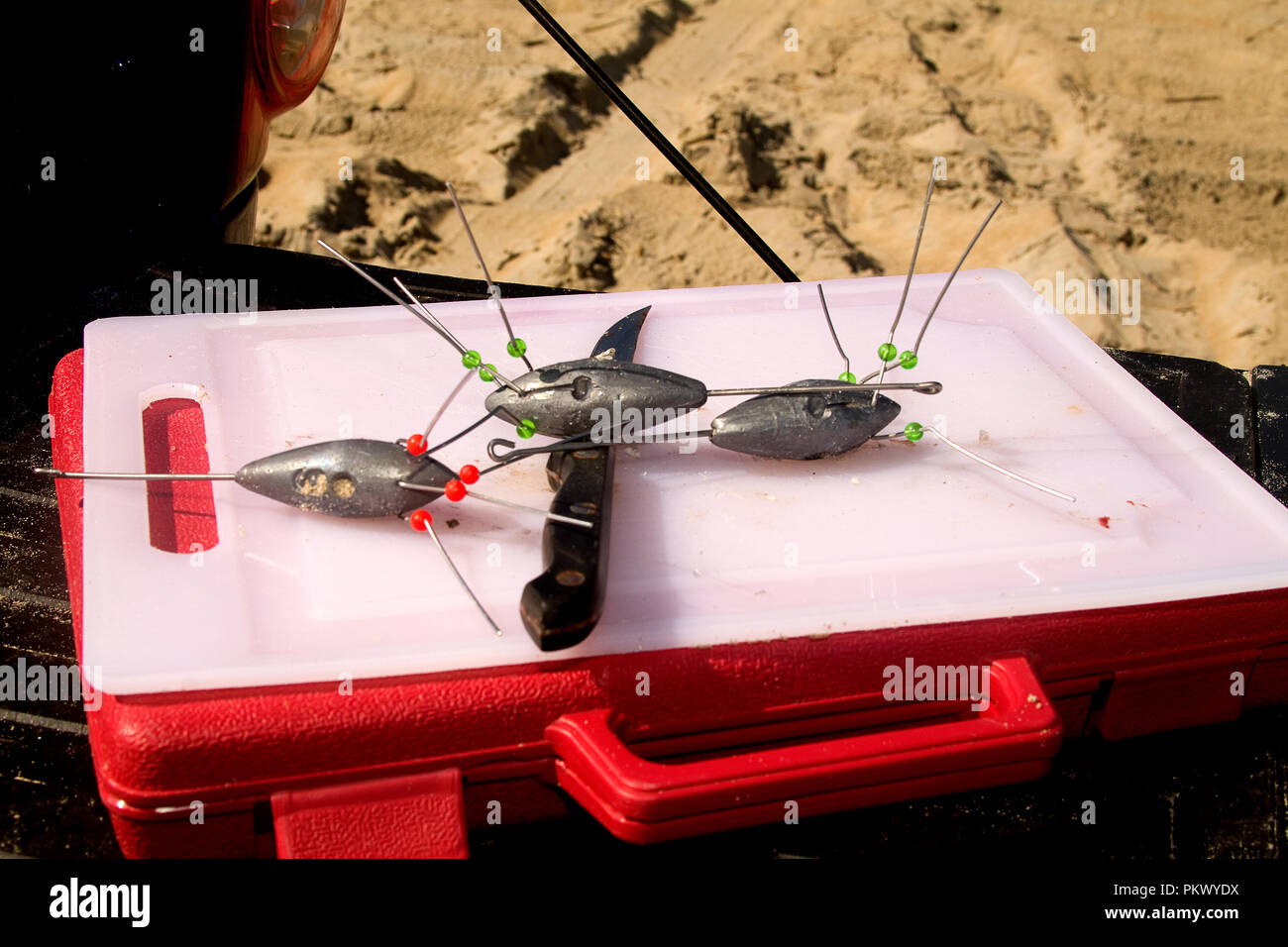 Tackle box with fishing cutting board laying on top including fishing  weights and knife Stock Photo - Alamy
