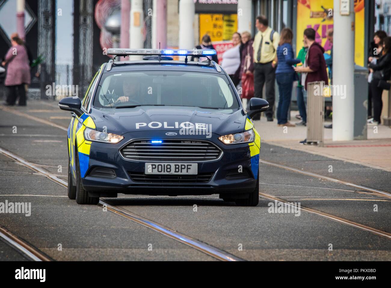 999 Emergency Police Responders; Vehicles using sirens and blue lights rush to crime incident in Blackpool, UK Stock Photo