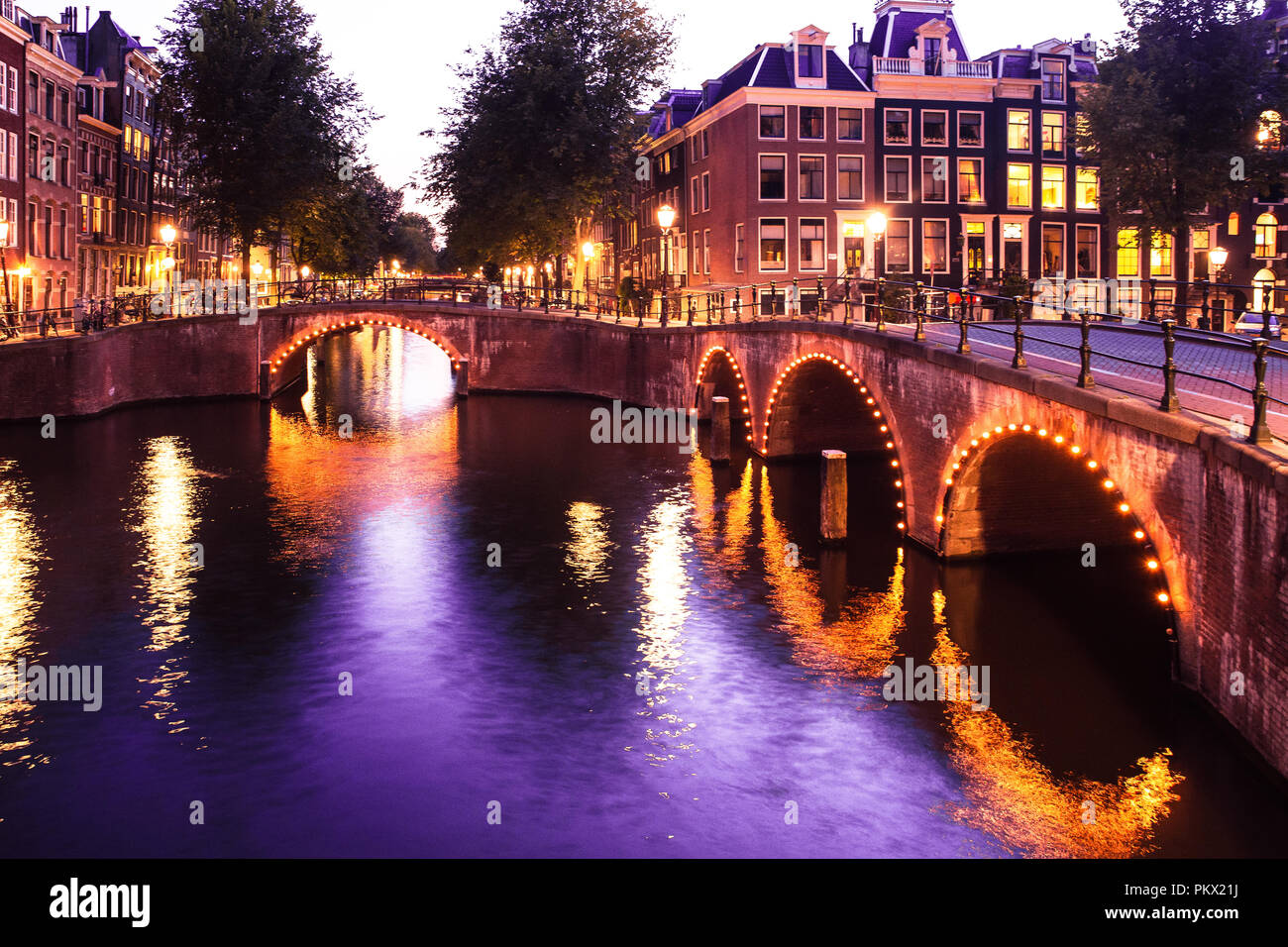 Beautiful night scene from the City of Amsterdam in the Netherlands with  canals and lights Stock Photo - Alamy