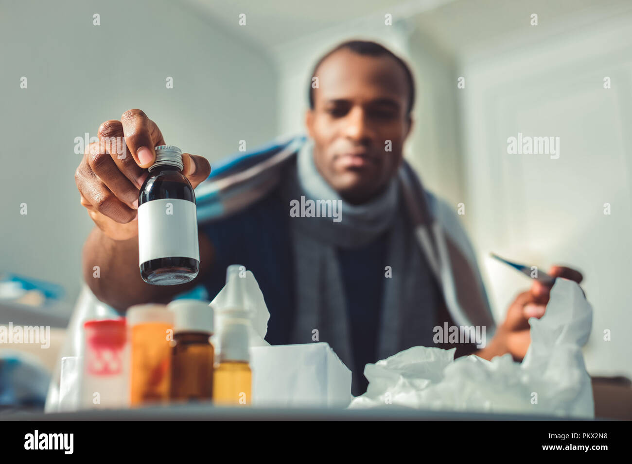Pleasant adult afro american man taking drug Stock Photo