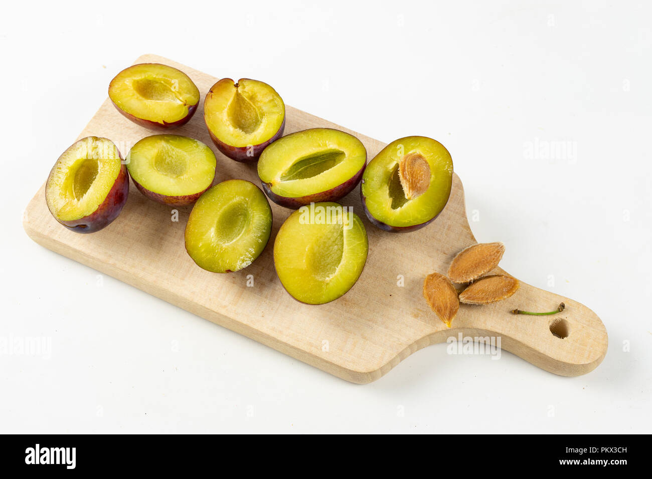 https://c8.alamy.com/comp/PKX3CH/fresh-plums-prepared-for-jam-tasty-fruits-on-a-wooden-board-in-the-kitchen-white-background-PKX3CH.jpg