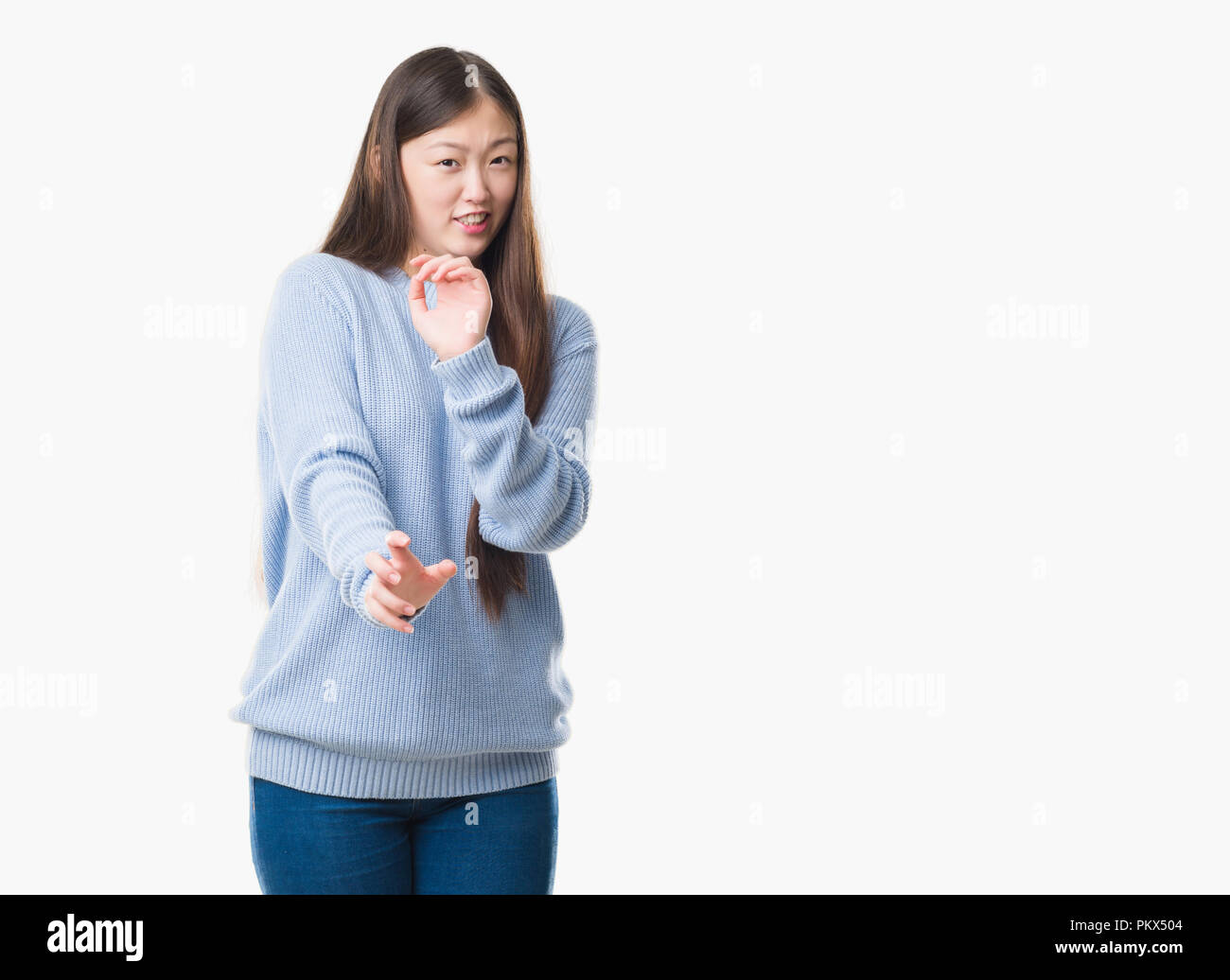 Young Chinese woman over isolated background disgusted expression ...