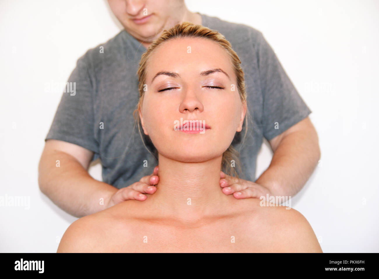 Massage relax studio. Woman having her neck massaged by a