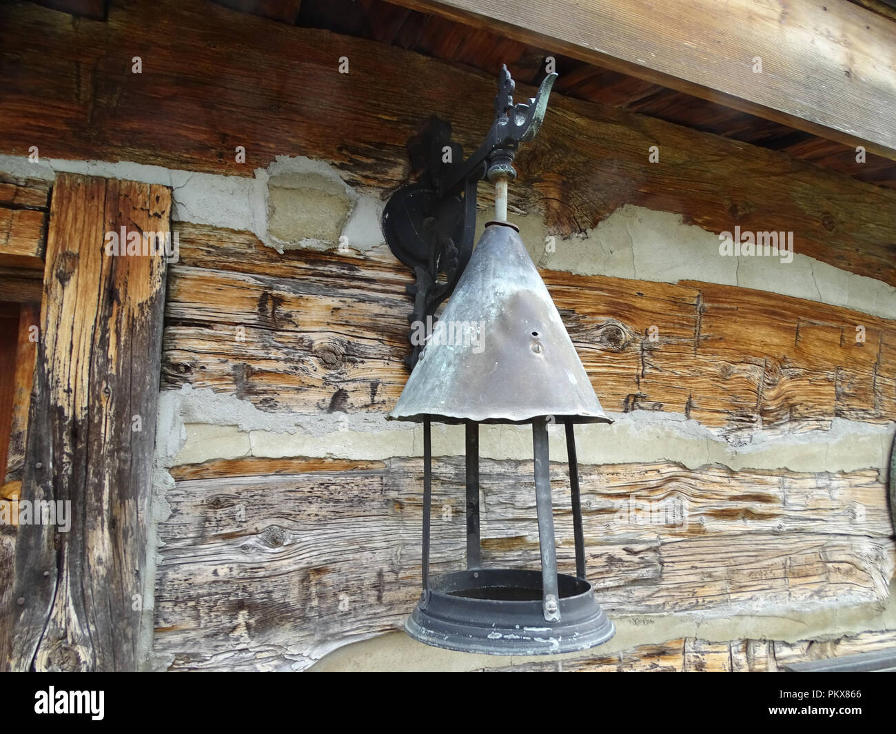 An antique outdoor lamp hanging from a bracket Stock Photo Alamy