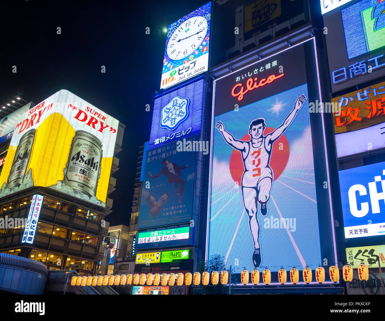 The lit colourful signboards (billboards), including the famous Glico Man and Asahi Super Dry signs of Dotonbori in the Namba district, Osaka, Japan. Stock Photo