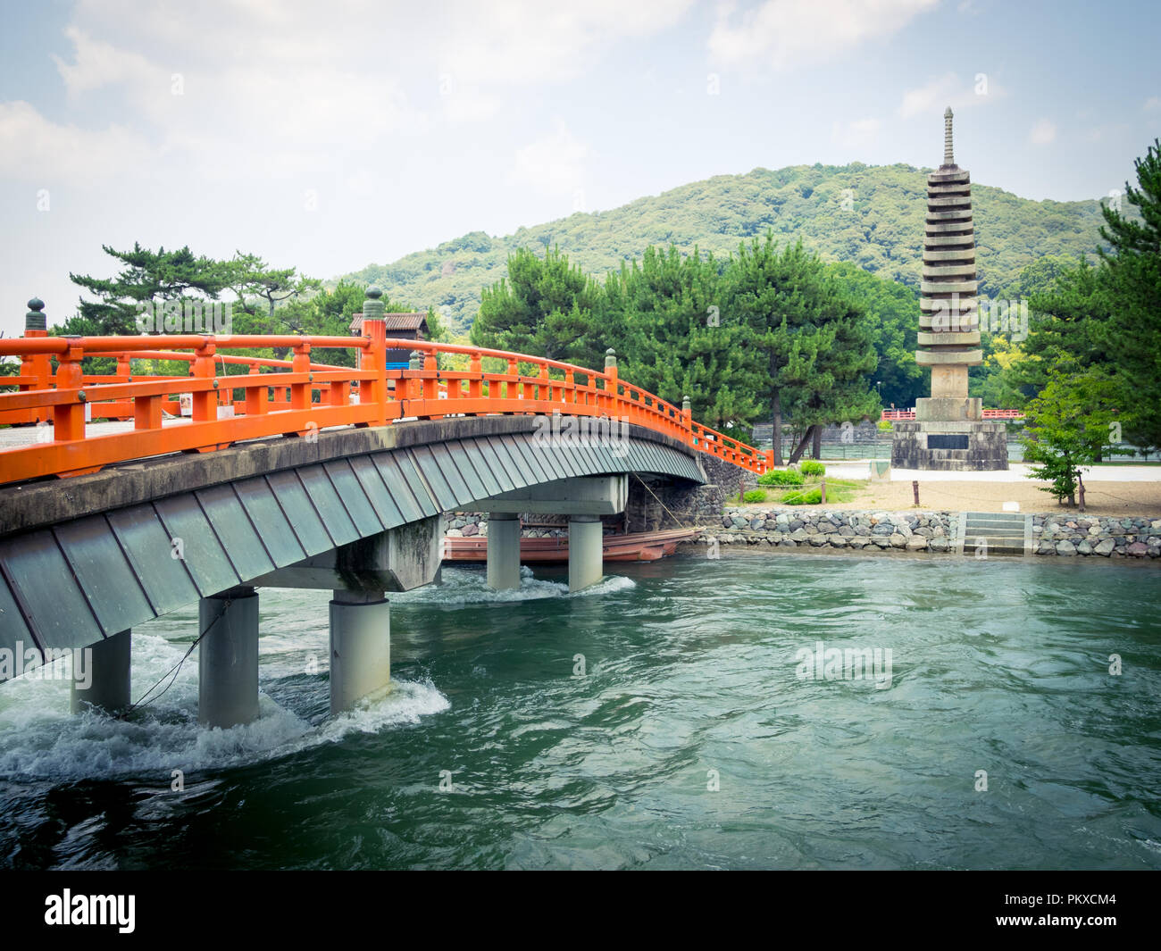 The Kisenbashi (Kisen-bashi, Kisen) Bridge and the 13-tiered stone pagoda (Jusanju Sekito) on Tonoshima (Tono-shima) Island in Uji, Japan. Stock Photo