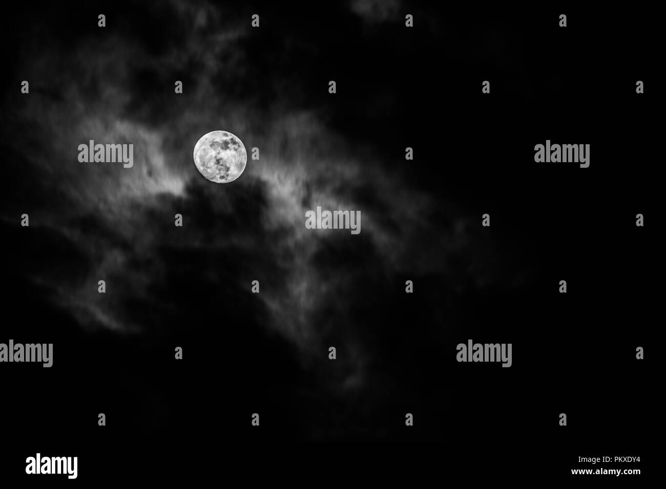 Full moon in the middle of clouds Stock Photo