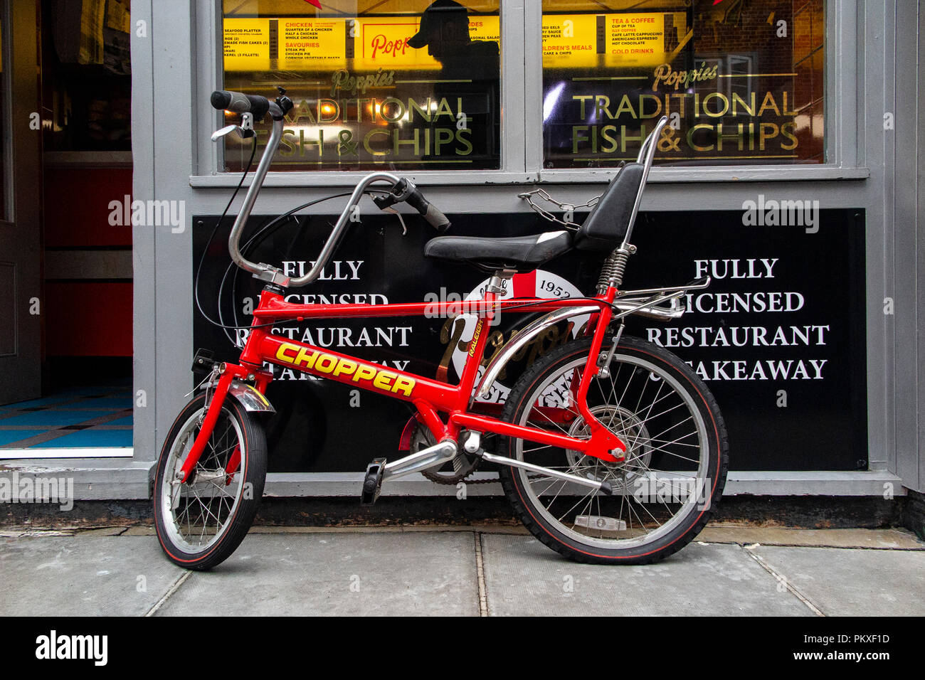 An immaculate Raleigh Chopper parked outside a fish and chip shop in London's Soho Stock Photo