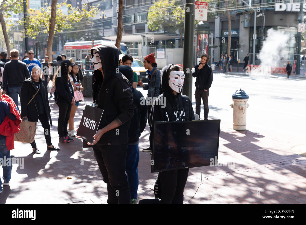 Cube of Truth/Anonymous for the Voiceless, vegan activists in Guy Fawkes masks; Market Street, San Francisco, California, USA Stock Photo