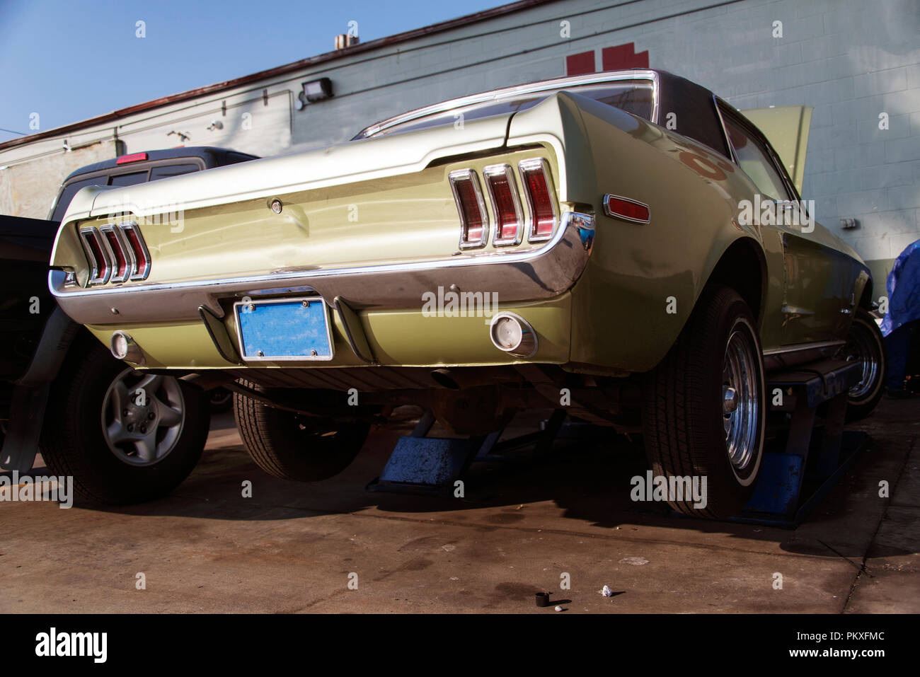 A vintage classic American car on the lift in a repair shop in Venice ...