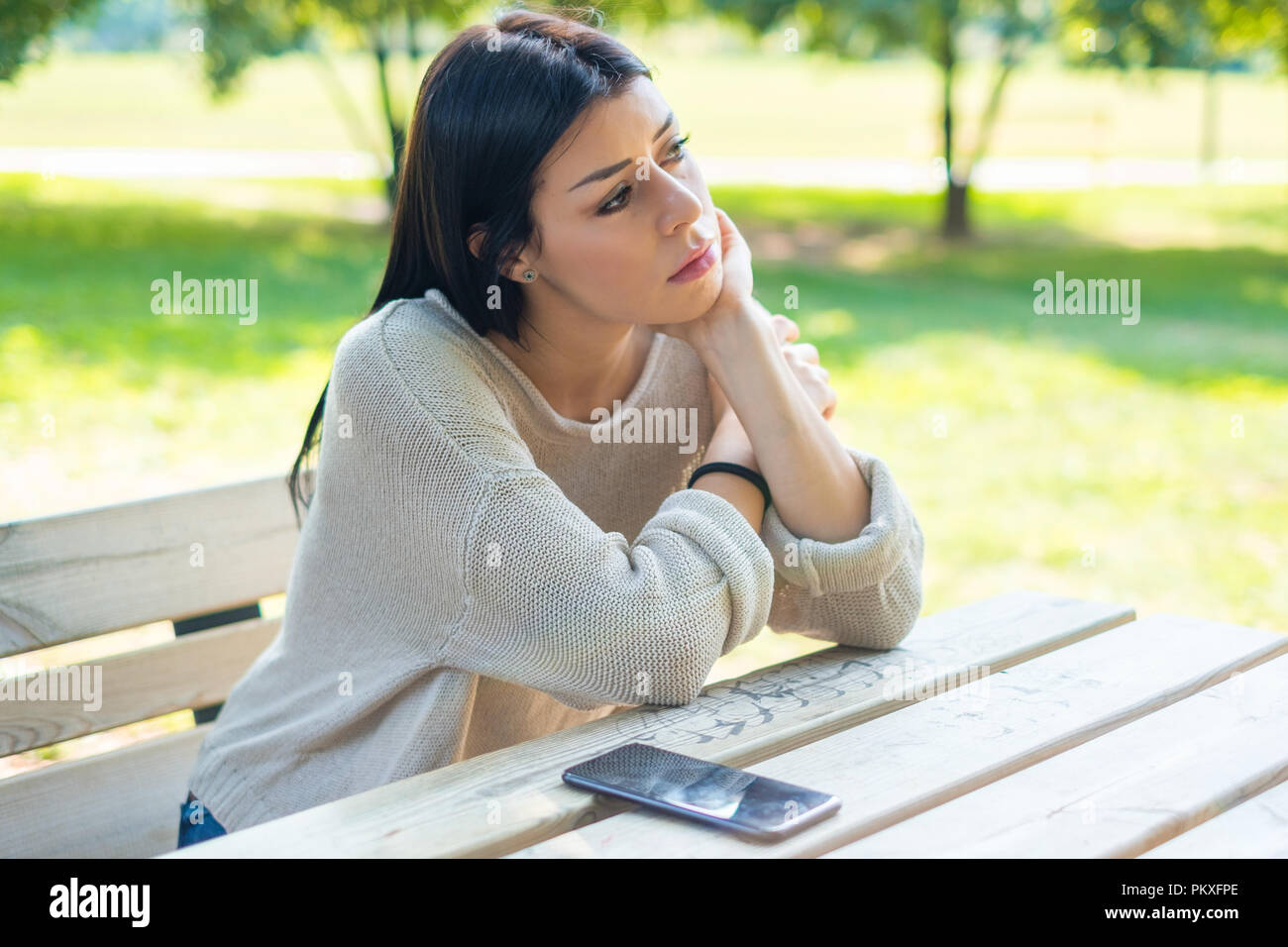 Girl waiting for a mobile phone message feeling sad Stock Photo ...