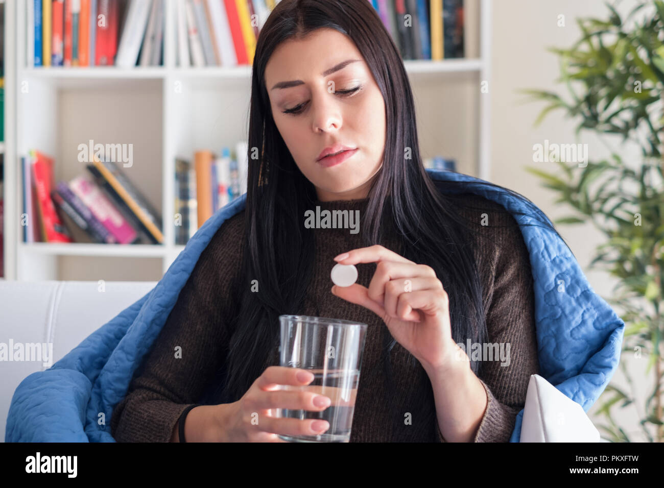 Young woman taking an aspirin pill against headache Stock Photo Alamy