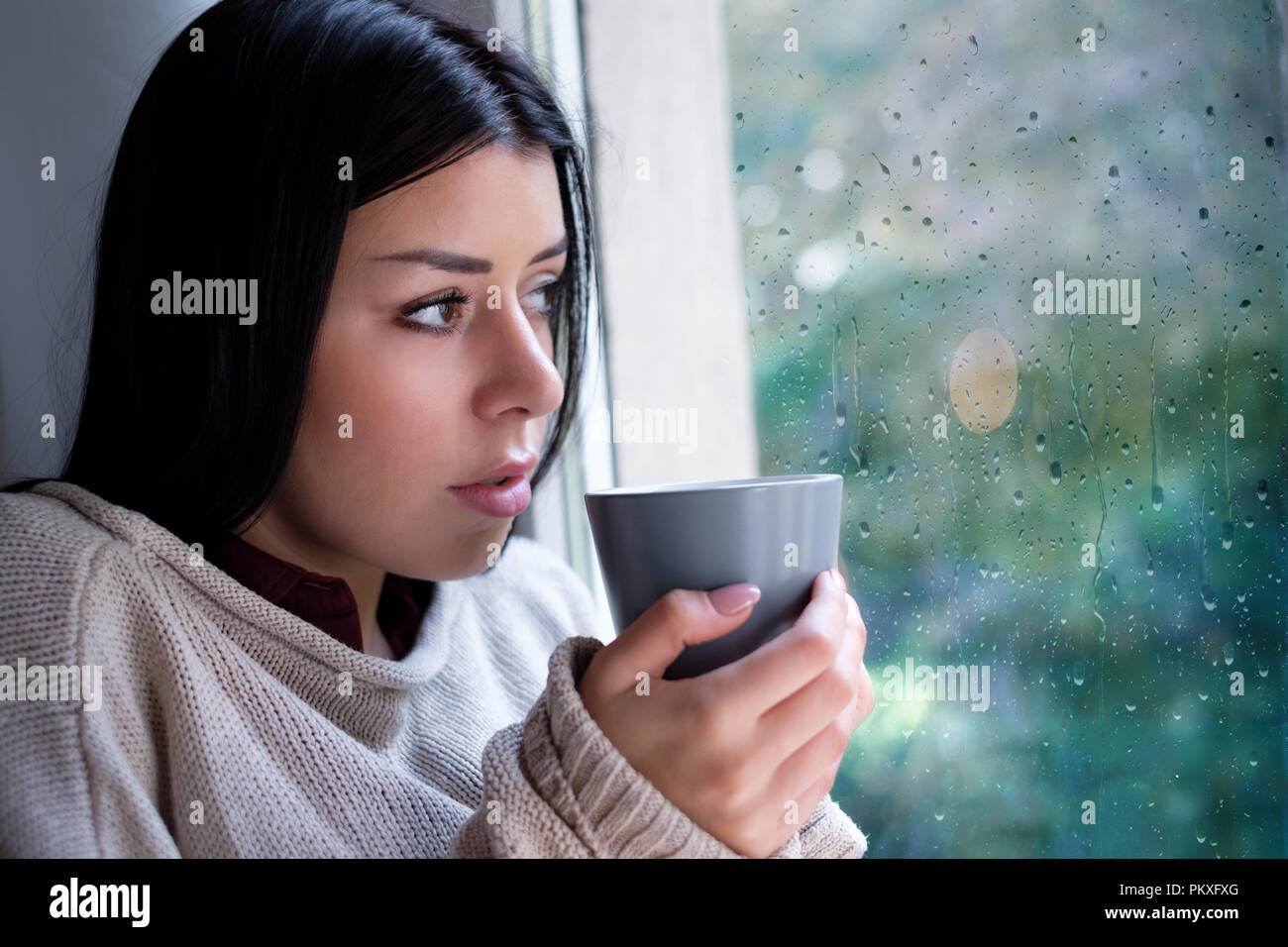 Woman drinking coffee on rainy hires stock photography and images Alamy