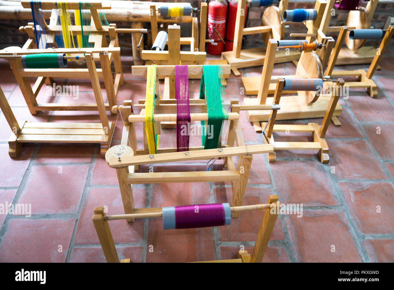 Wooden spools with colored silk threads. Stock Photo