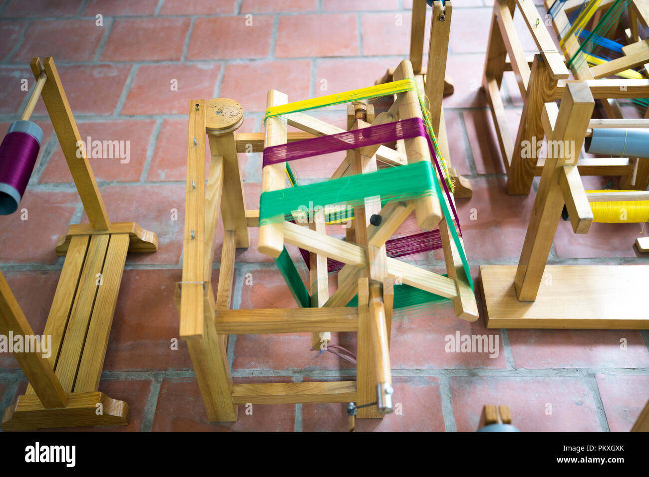 Wooden spools with colored silk threads. Stock Photo