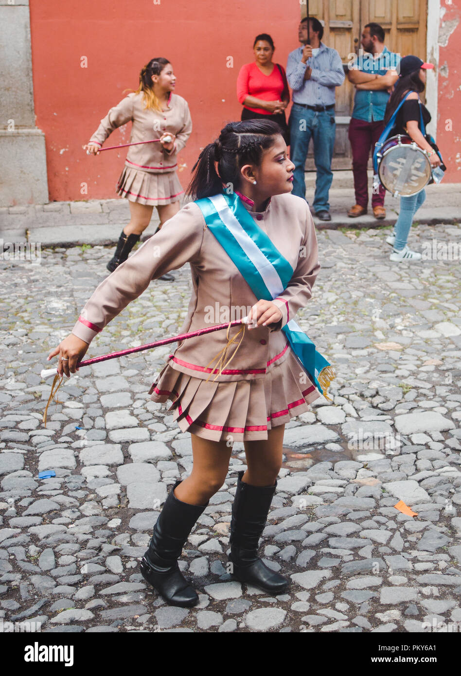 Young girls in uniform dance in a marching band street parade for Dia de la Independencia (Independence Day) in Antigua Guatemala 2018 Stock Photo