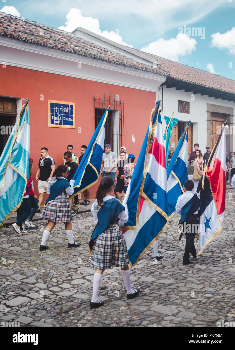 Children carry flags of Guatemala, Costa Rica, Nicaragua, El Salvador & Honduras as part of a marching parade for Dia de la Independencia in Antigua Stock Photo