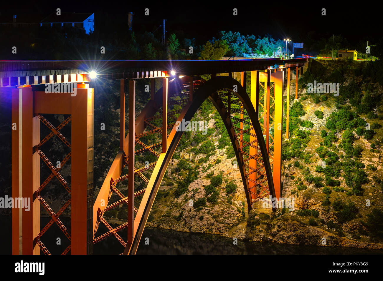 Illuminated bridge at night, steel arch construction Stock Photo