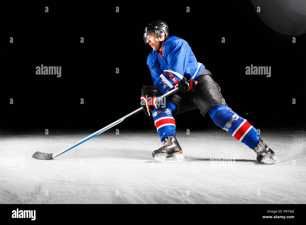 Hockey player turning around skating on ice Stock Photo Alamy