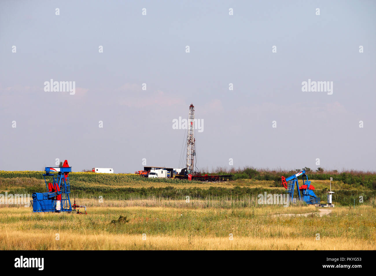 oil drilling rig and pump jacks on oilfield Stock Photo Alamy