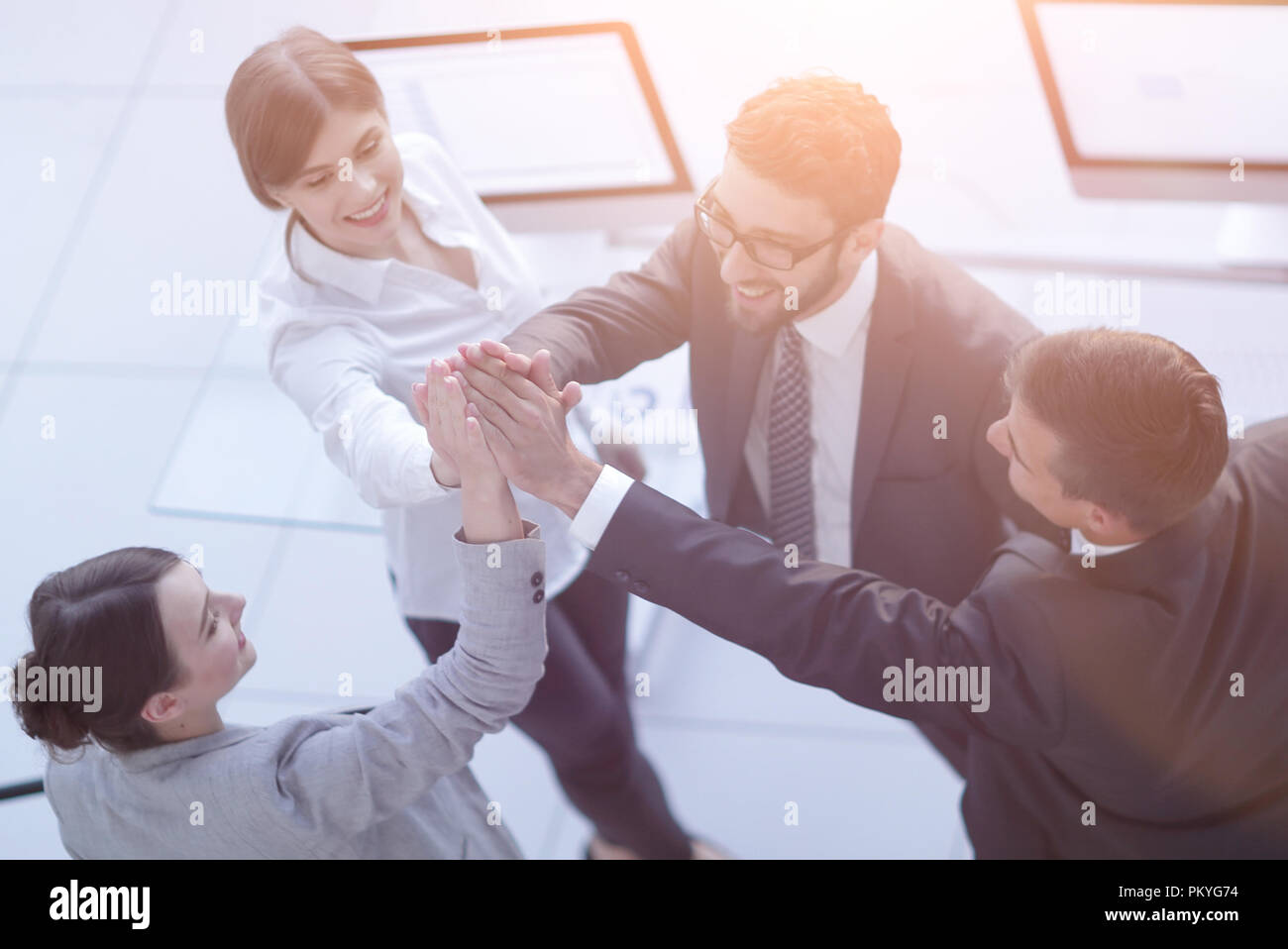 successful business team giving each other a high-five, standing in the ...