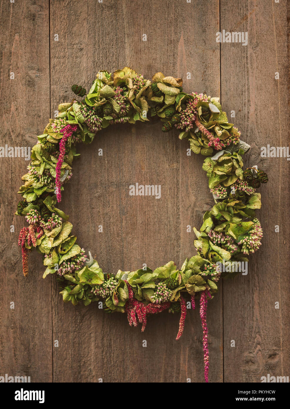 Rustic, decorative wreath hanging on door or laying on table. Stock Photo