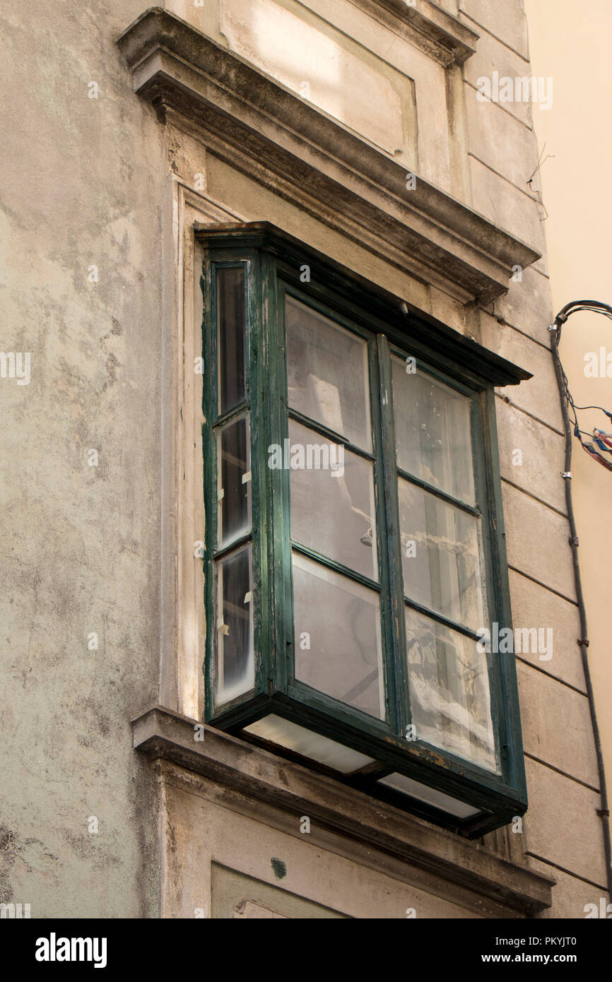 Weathered vintage wooden green window in the old town Sibenik, Dalmatia. This type of window is usually called bay , garden or green house window. Stock Photo