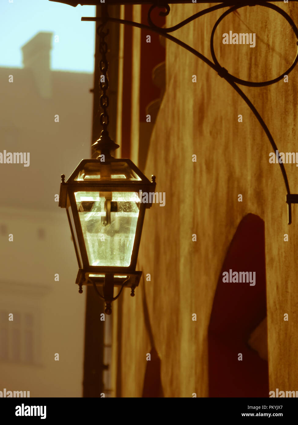 Backlit stylish street lantern in the morning fog Stock Photo