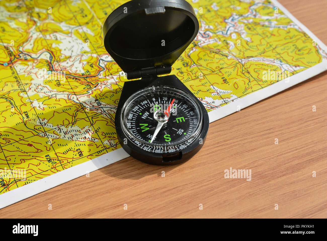 Compass and map. The magnetic compass is located on a topographic map ...
