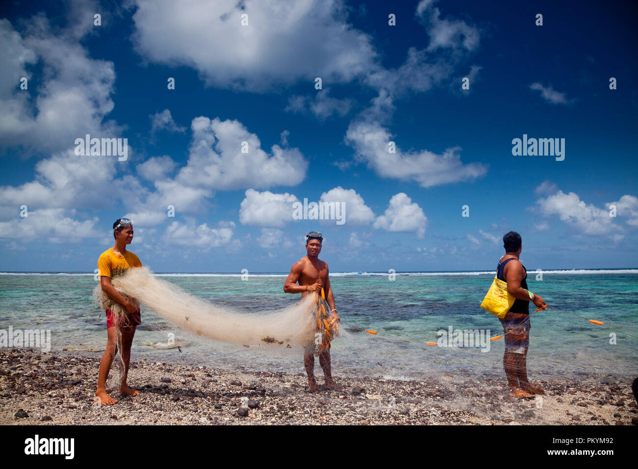 Locals prepare a fishing net to catch fish in the lagoon at Lepa