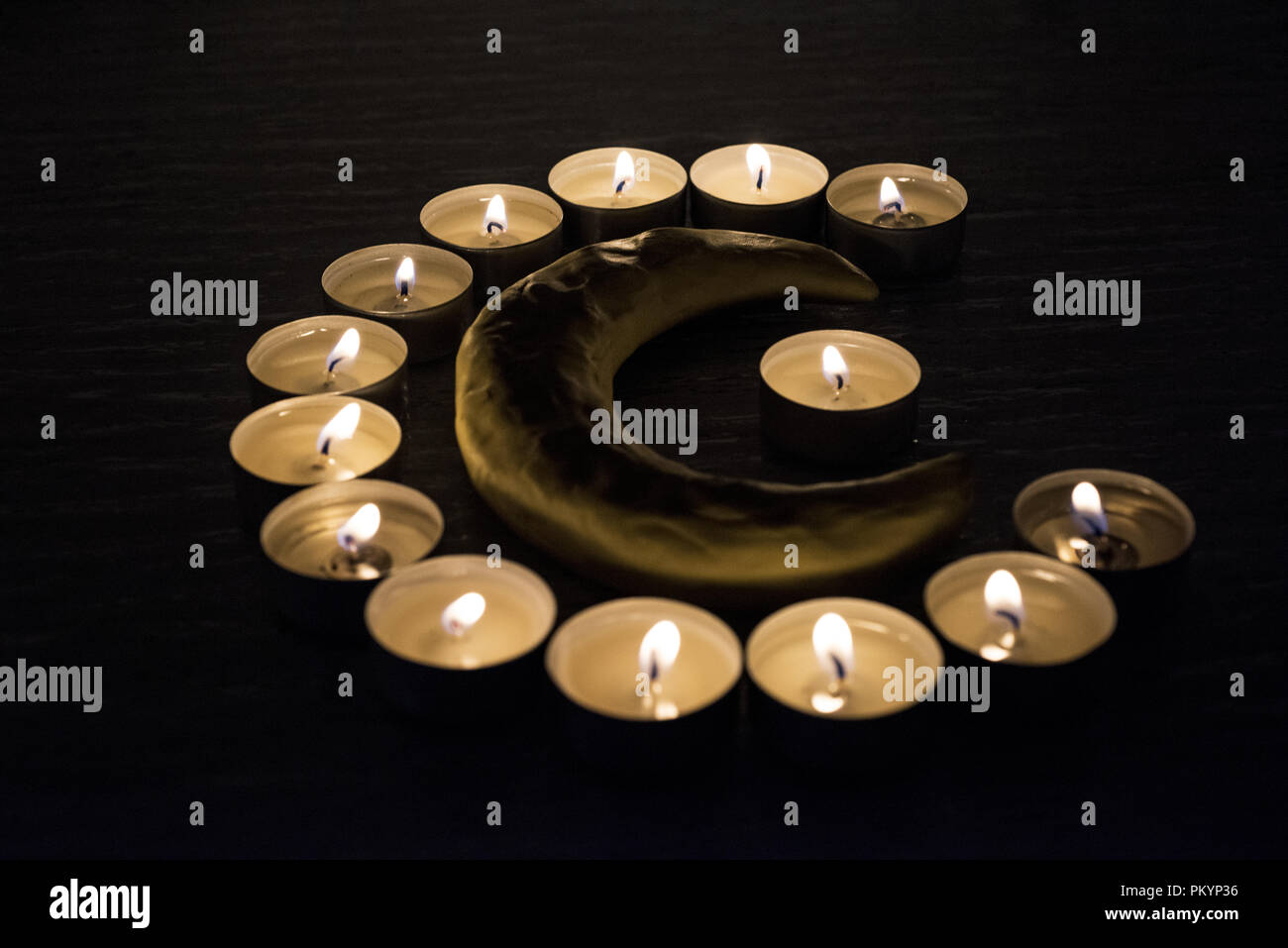 Symbols of Islam. Candle lights on black background. Abstract isolated