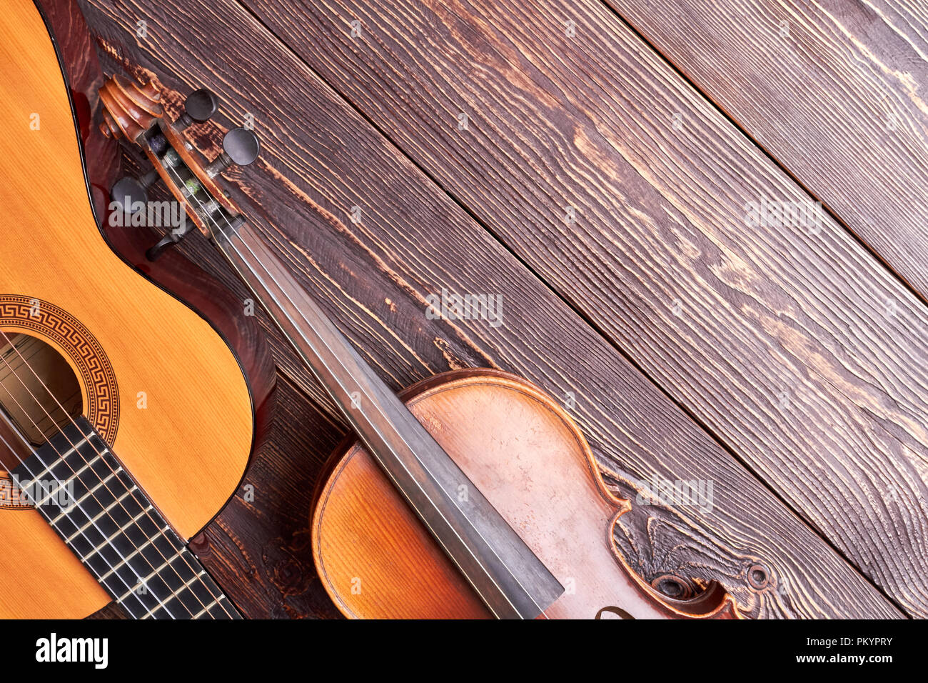Classical violin and guitar on wooden background. Jazz guitar, violin