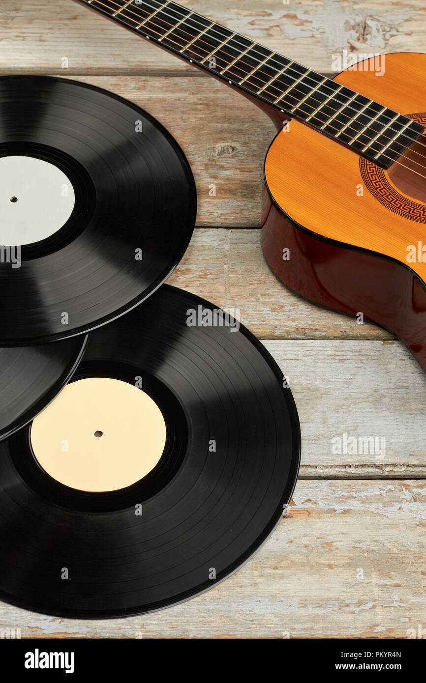 Acoustic guitar and vinyl records. Gramophone records and wooden guitar