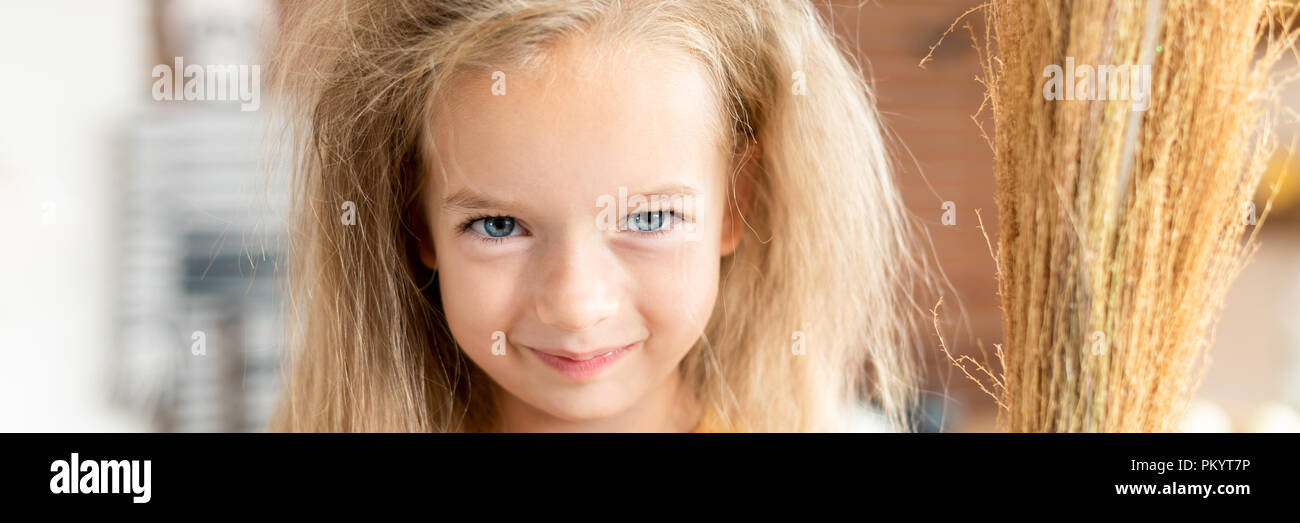 Cute Little Girl With Messy Hair Dressed Up As A Witch Holding A