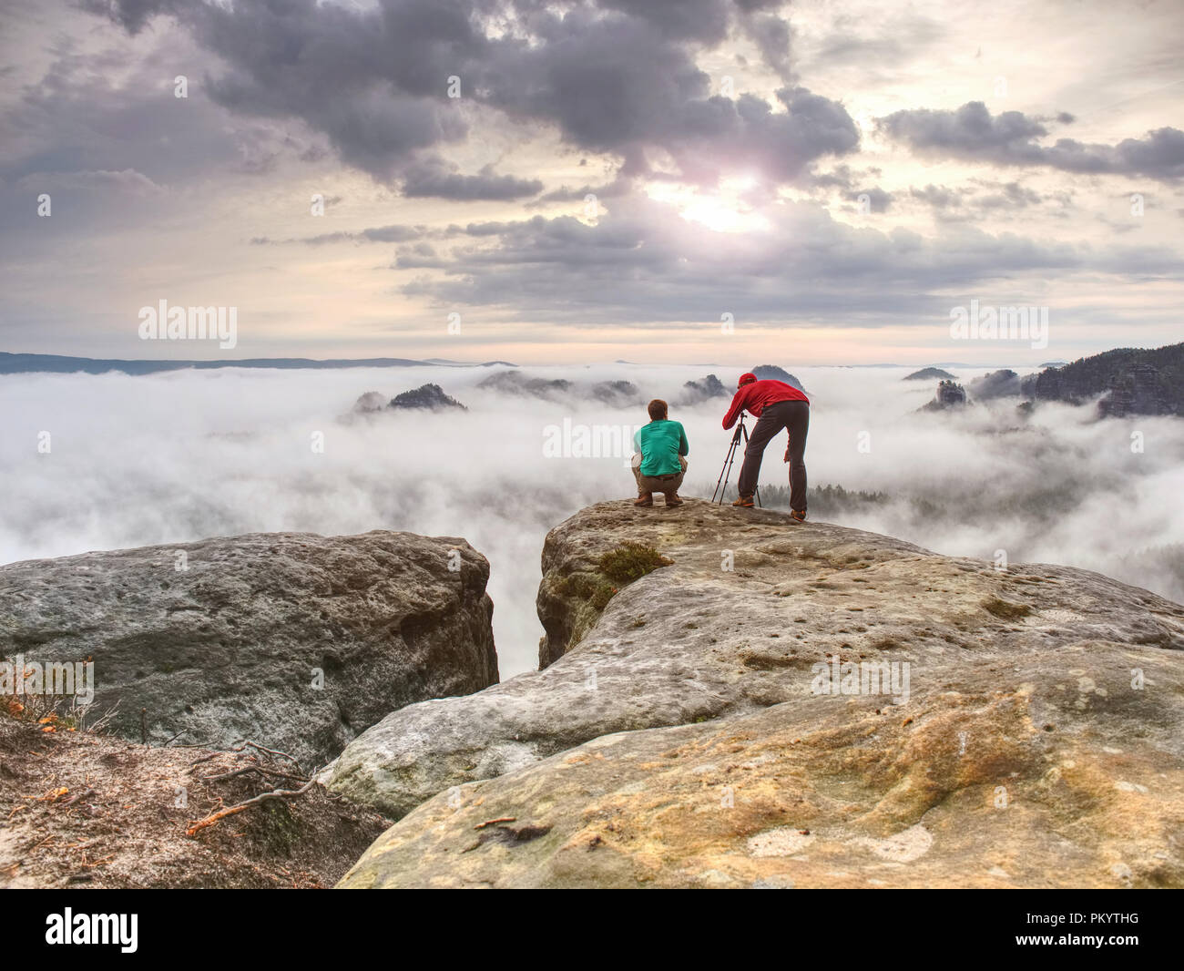 Travel photographer man taking nature video of mountain lookout. Hiker tourist professional photographer and videographer on adventure vacation shooti Stock Photo