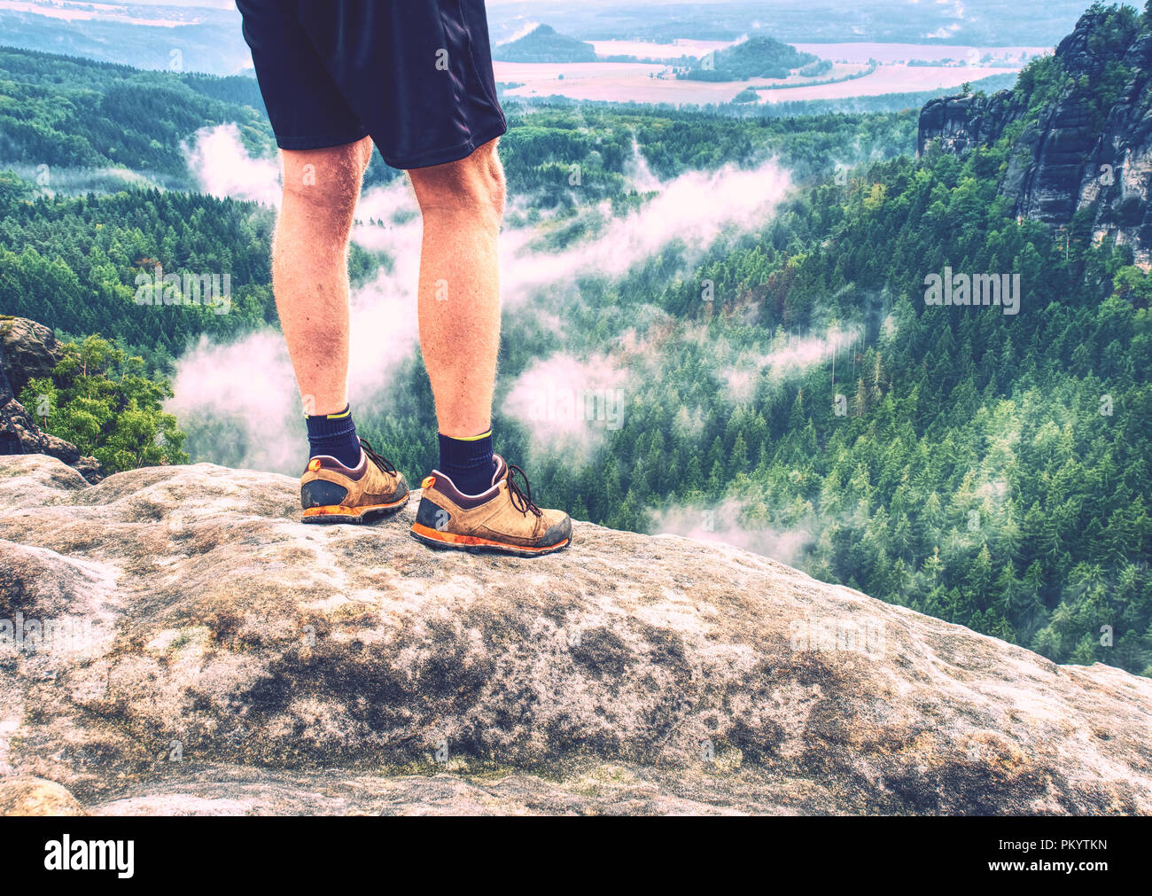 Walking comfortable shoes. All terrain shoes. Hiking  boots on hiker outdoors walking crossing rocky traail. Fall hike in pure nature Stock Photo