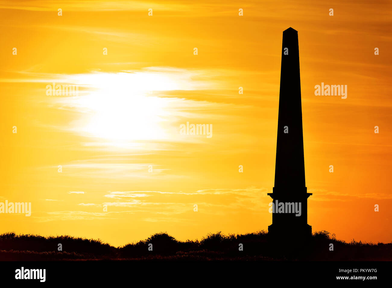 Seaton Deleval Hall obelisk in corn fields at sunset Stock Photo