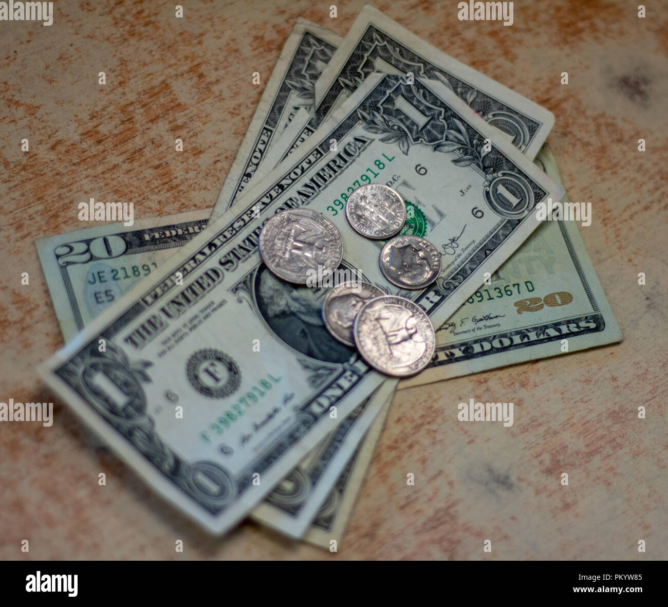U.S. currency bills and change. money on table. Stock Photo