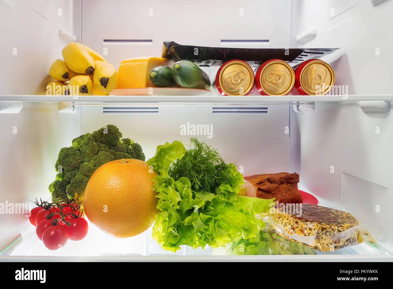 Fresh food in the fridge. Fruits, vegetables, beer, cheese and meat into coldstore Stock Photo