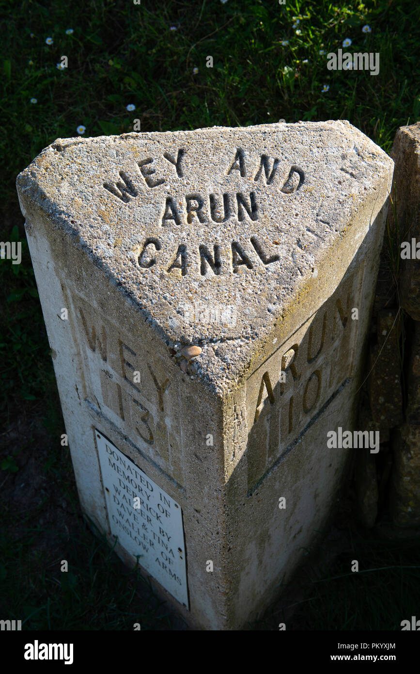 A milepost on the Wey & Arun canal at Loxwood in West Sussex, England, UK Stock Photo