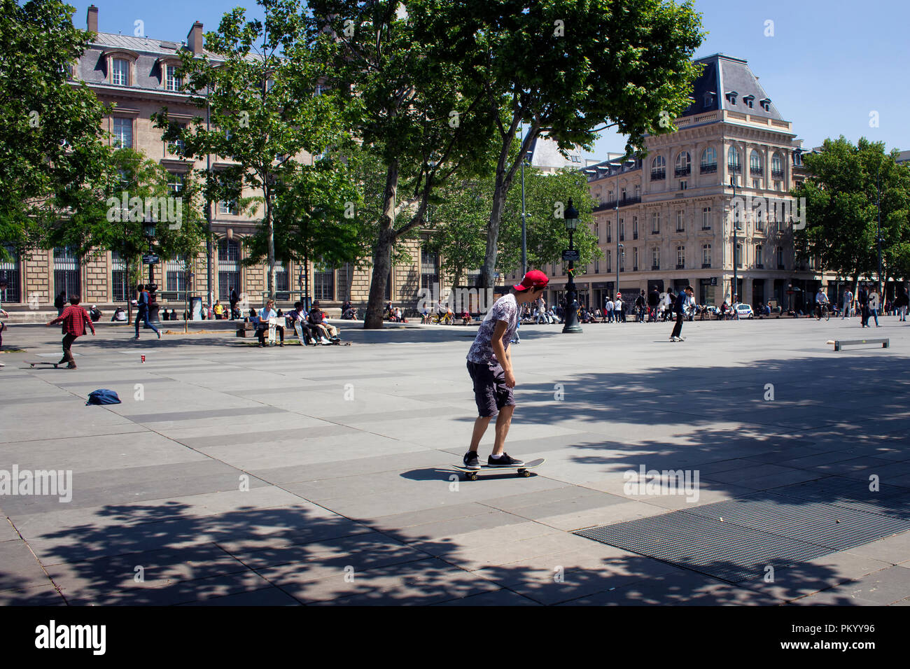 Young people skate at Republic square (Place de la Republique) in Paris. The image shows the youth culture of the city. Stock Photo