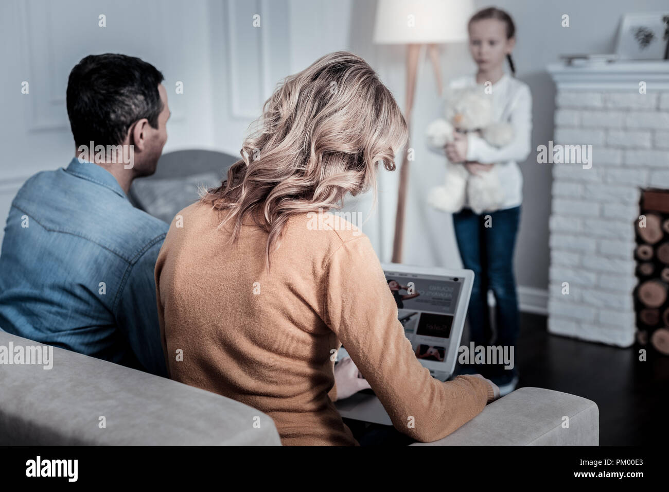 Busy parents working remotely Stock Photo