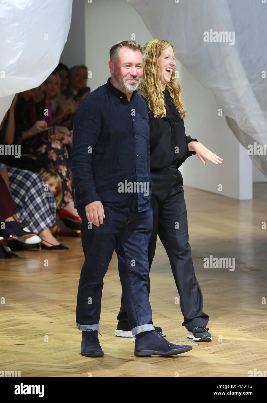 Designers Justin Thornton and Thea Bregazzi acknowledge the audience after their catwalk during the Preen by Thornton Bregazzi London Fashion Week September 2018 show at Lindley Hall, London Stock Photo