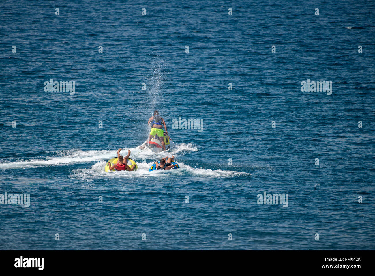 Jet ski pulling two tubes in water Stock Photo Alamy