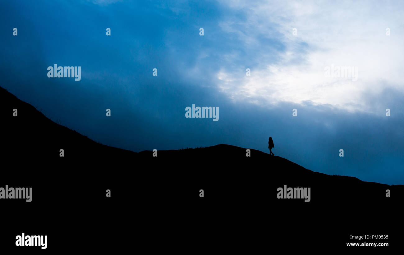 Silhouette walking on Llangynidr mountain Stock Photo
