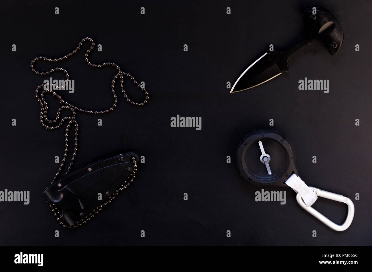 Knife and compass. Tourist accessories on a black background. Isolate